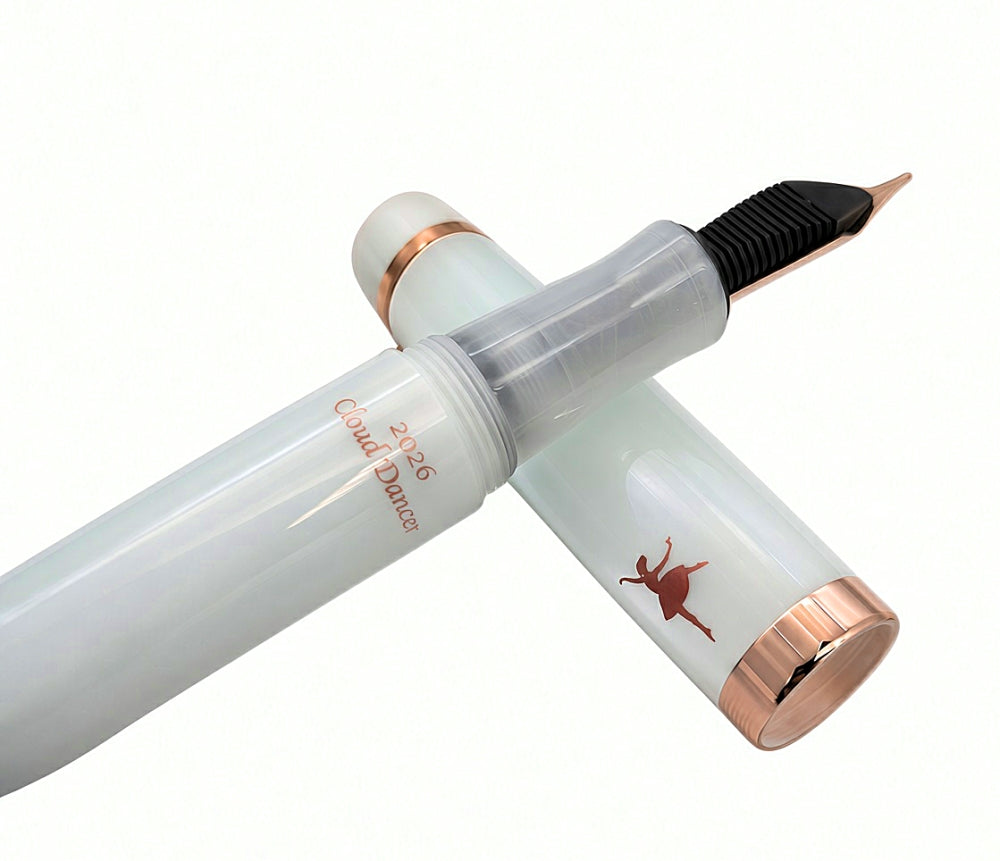 Translucent white Opus 88 Harmony fountain pen with copper-colored accents, featuring a silhouette of a dancer and the text 2026 Cloud Dancer on the barrel.
