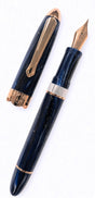 Nahvalur Horizon fountain pen in dark blue with a marbled, pearlescent finish and rose gold trim, shown with its cap removed.