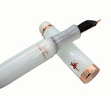 Translucent white Opus 88 Harmony fountain pen with copper-colored accents, featuring a silhouette of a dancer and the text 2026 Cloud Dancer on the barrel.