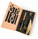 A Nahvalur Original Plus Fountain Pen - Fountain Pen Day 2026 (Limited Edition) boxed set featuring an amber and black Italian acrylic fountain pen, a gold feather-shaped bookmark with a dangling charm, and a circular pin.