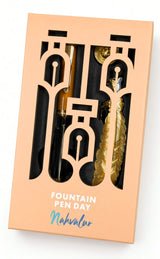A Nahvalur Original Plus Fountain Pen - Fountain Pen Day 2026 (Limited Edition) and a metallic feather-shaped bookmark inside a peach-colored box with cutouts and the text Fountain Pen Day.