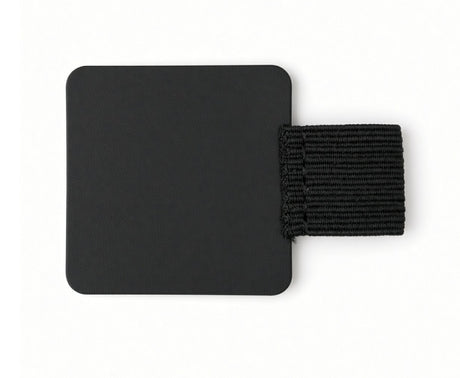 The FPR Pen Loop – self-adhesive pen notebook holder features a black square patch with rounded corners and an attached horizontal black elastic band, creating a sleek and practical journal accessory perfect for securely holding your pen on a white background.