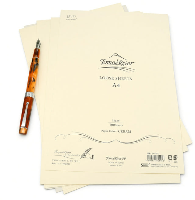 A stack of cream-colored Tomoe River A4 Loose-leaf Sheets next to a tortoiseshell fountain pen.