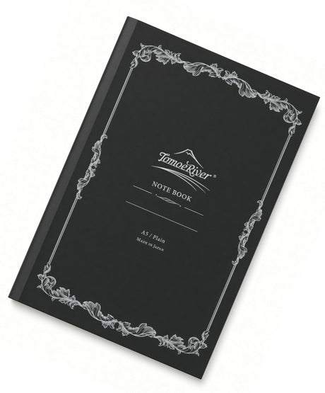 Black Tomoe River A5 Notebook - Blank with a silver ornate border and the text Tomoe River NOTE BOOK A5 / Plain MADE IN JAPAN on the front cover.