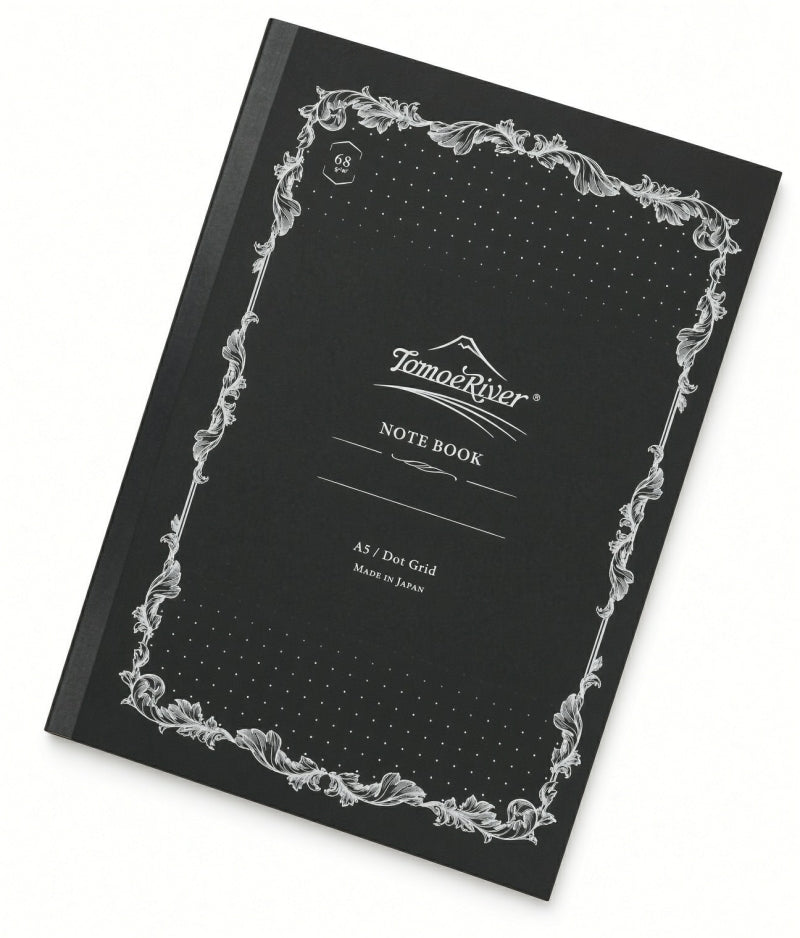 Tomoe River A5 Notebook - Dot Grid (68gsm) with a black dot grid cover, white ornate border, and a central label reading NOTE BOOK with A5 / Dot Grid text below.