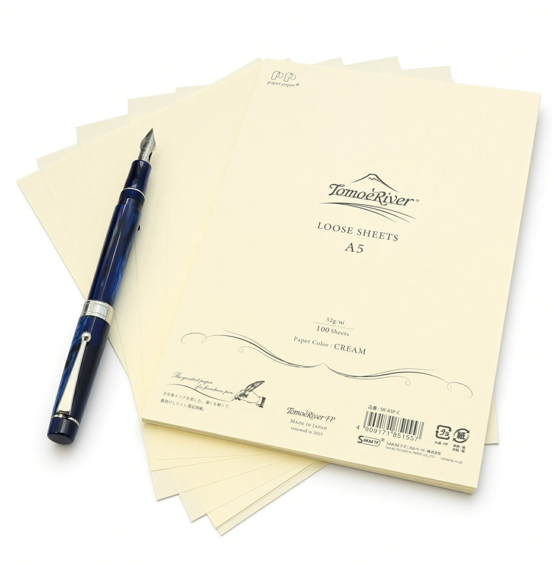 A stack of cream-colored Tomoe River A5 Loose-leaf Sheets (52gsm) with a blue fountain pen resting on top.