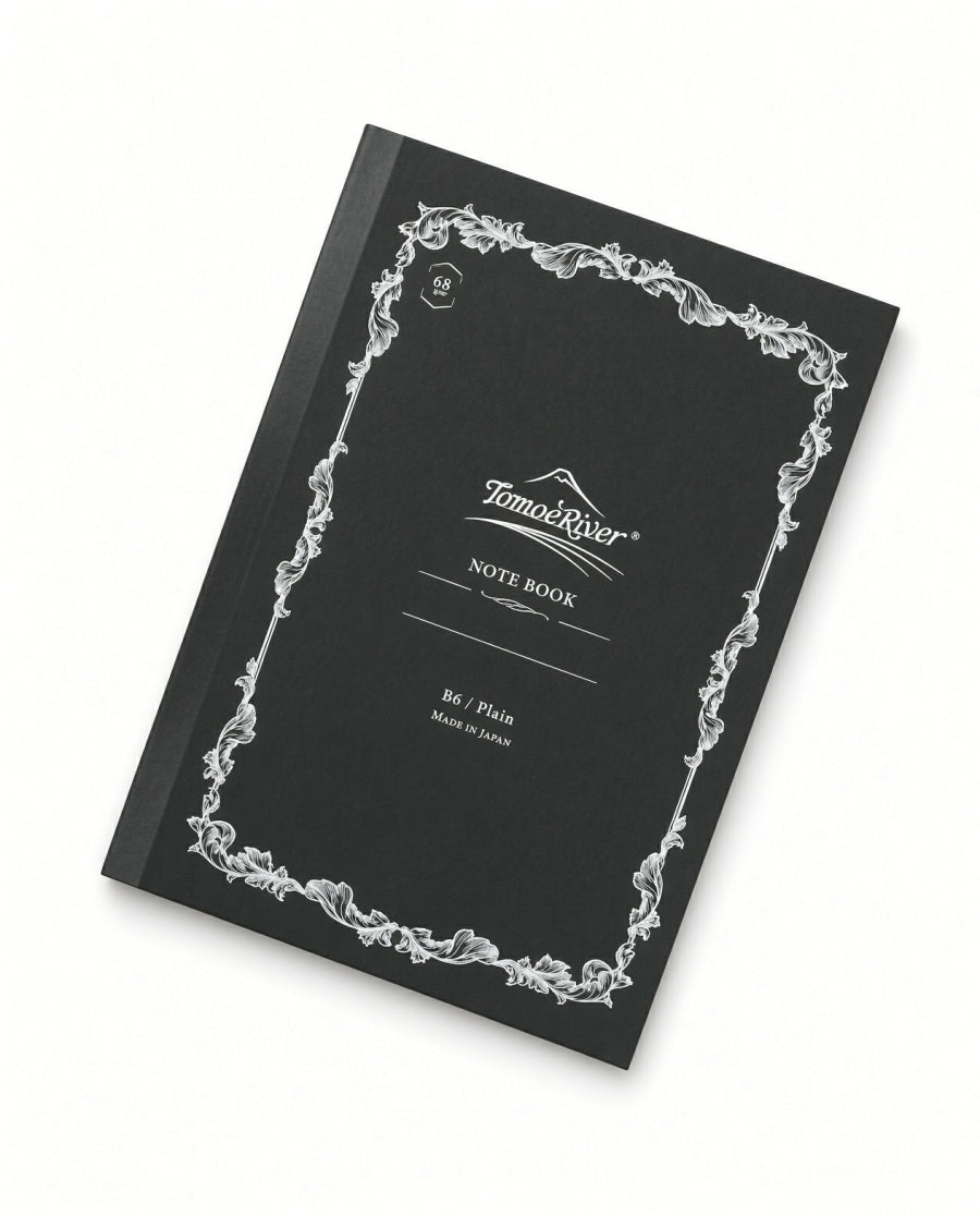 Black B6 Tomoe River B6 Notebook -Blank (68gsm) with a white ornate leaf border and NOTE BOOK printed on the cover, featuring fountain pen friendly paper.
